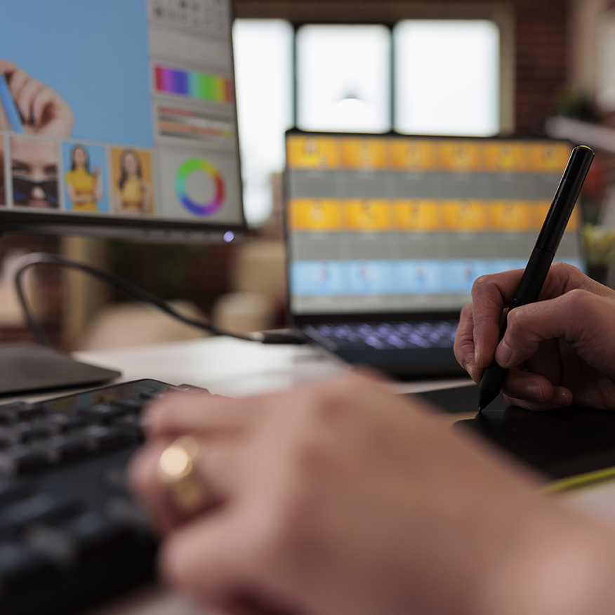 Female editor using stylus on graphic tablet Female editor using stylus on graphic tablet